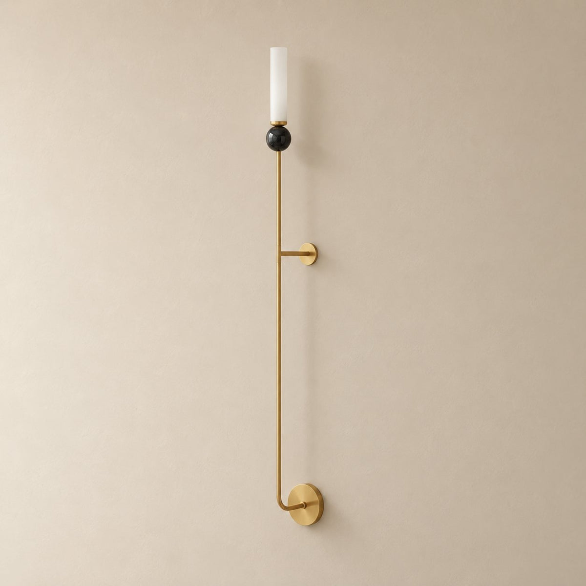Aljezur vertical marble wall sconce in brass with black marble, Model C (115 cm), unlit on a plain plaster wall.
