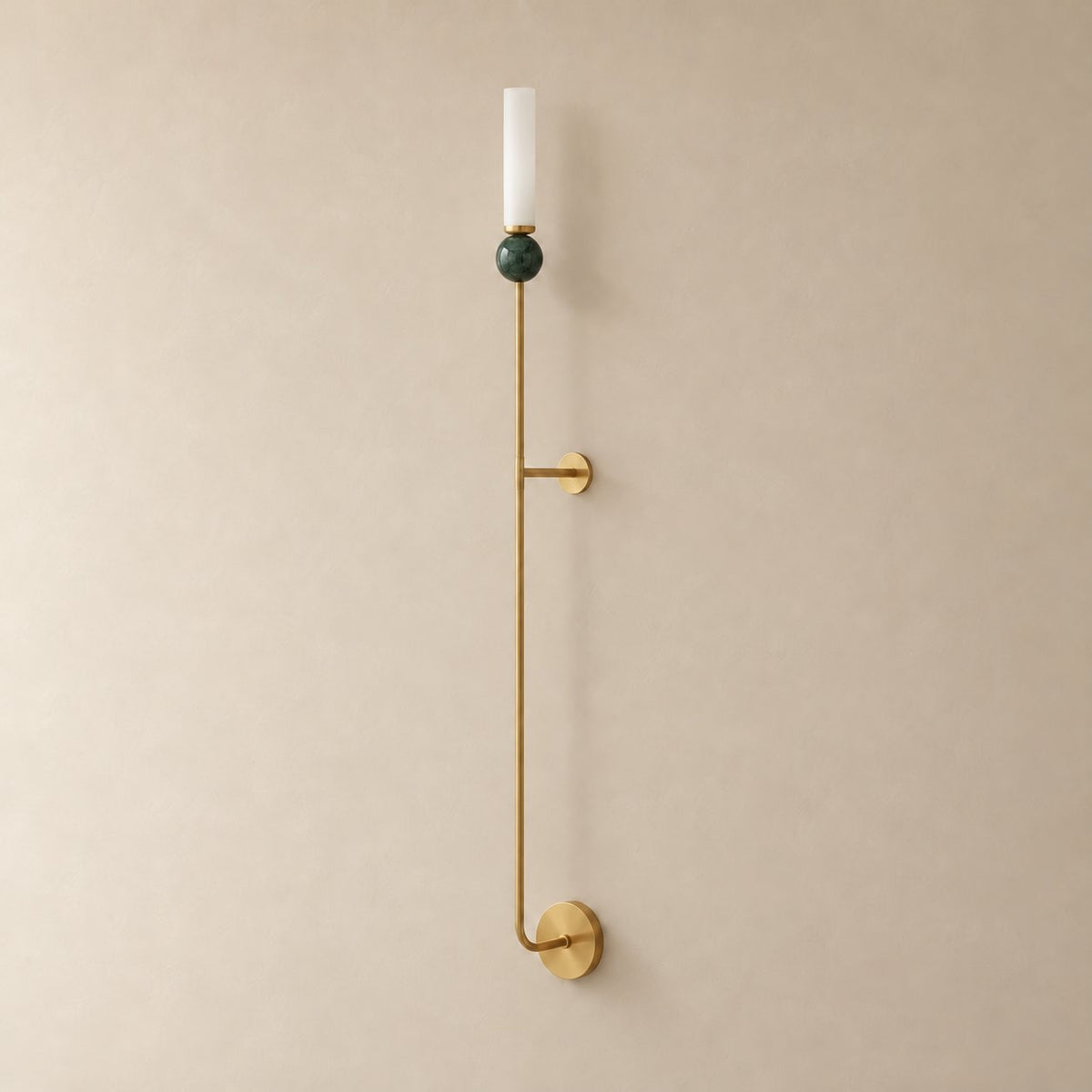 Aljezur vertical marble wall sconce in brass with green marble, Model C (115 cm), unlit on a plain plaster wall.
