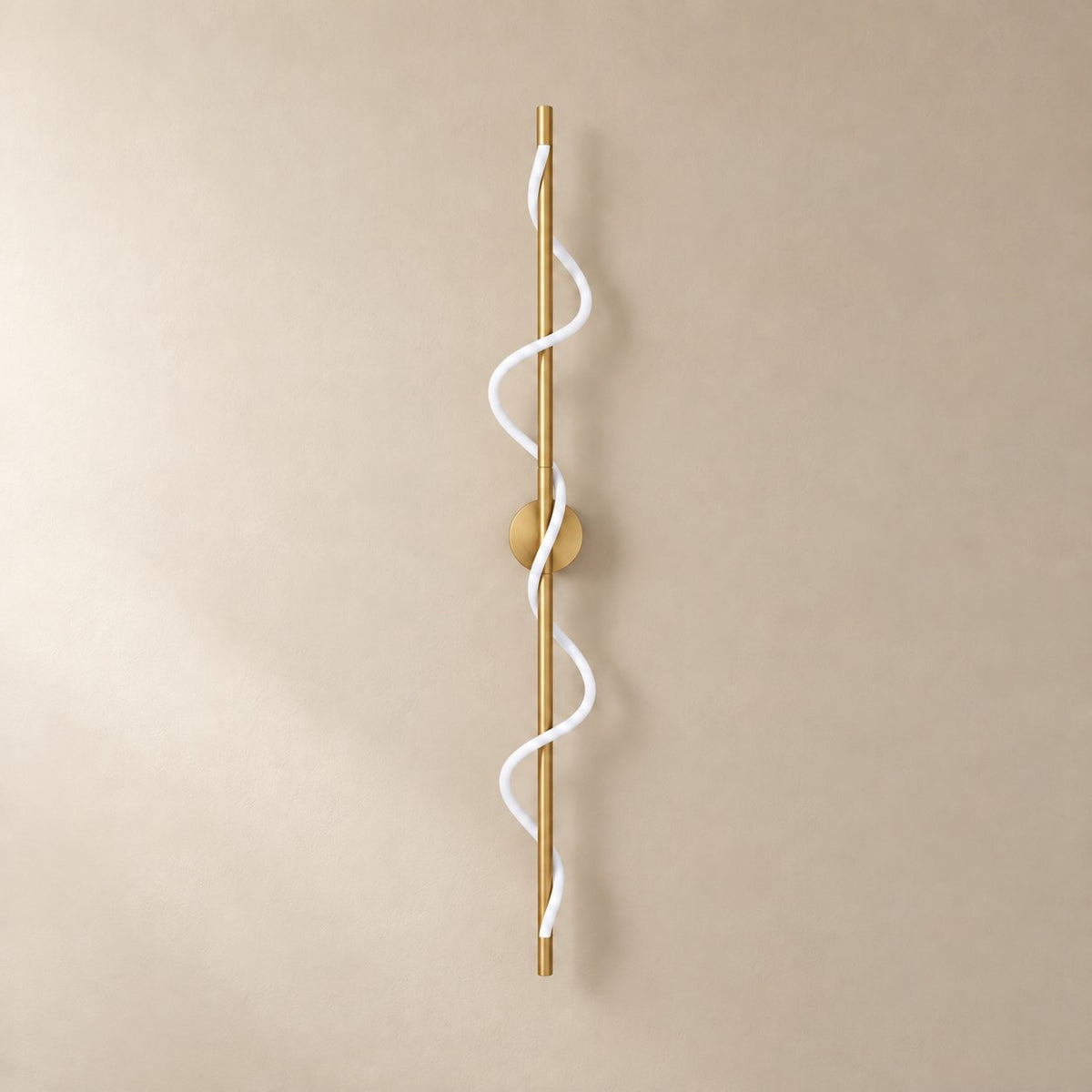 Alvito linear flexible wall sconce in brushed brass, 120 cm, unlit on a plain plaster wall.
