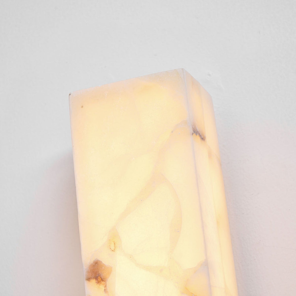 Amieira sconce mounted on living room accent wall