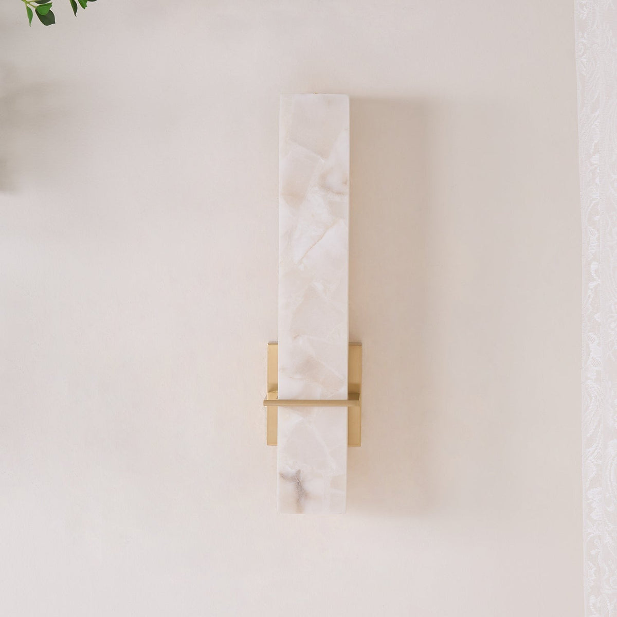 Amieira sconce with warm light activated, glow detail