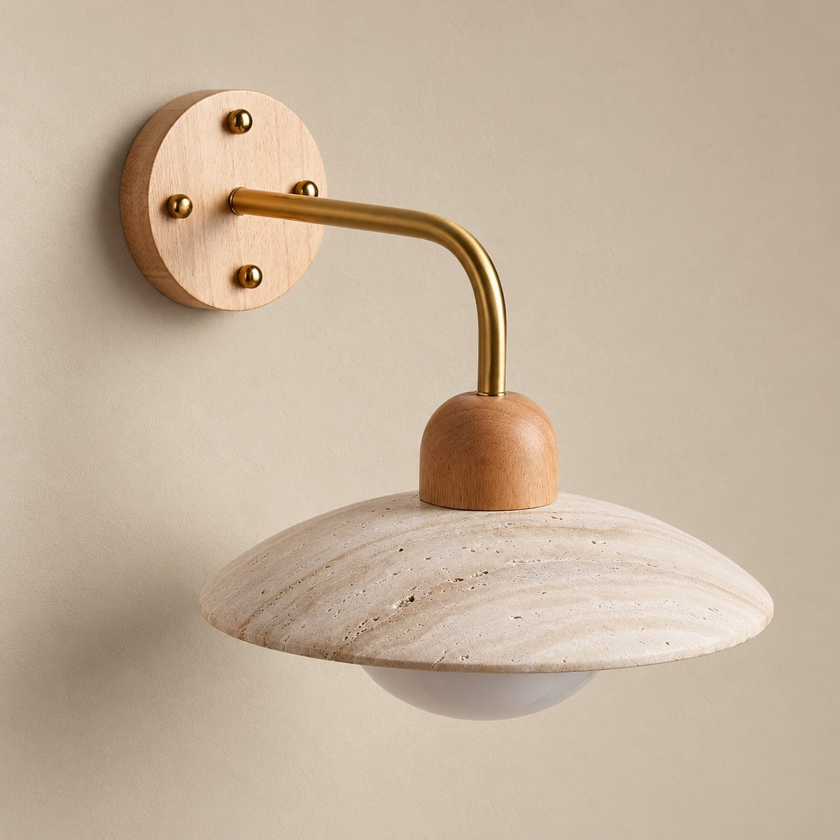 Boticas dome arm wall sconce in brass and light wood, unlit on a plain plaster wall.