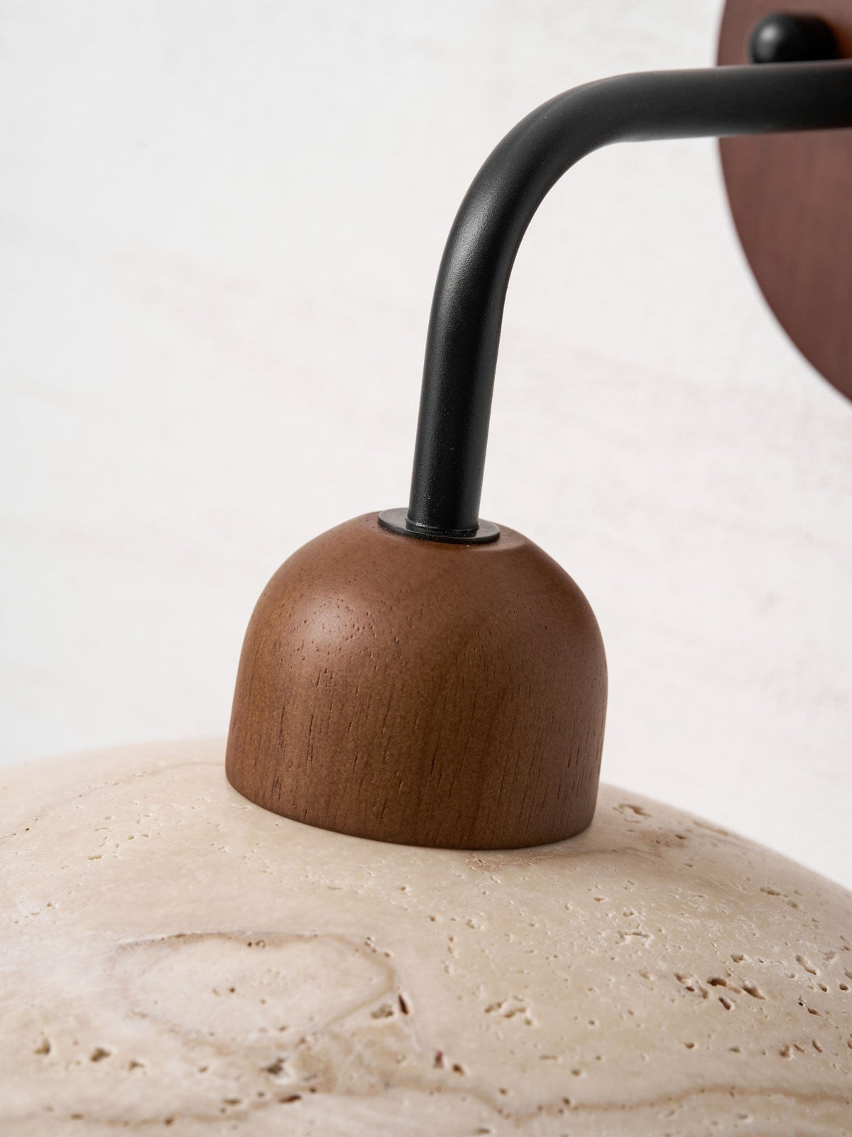 Boticas dome sconce showing wood backing and brass curve