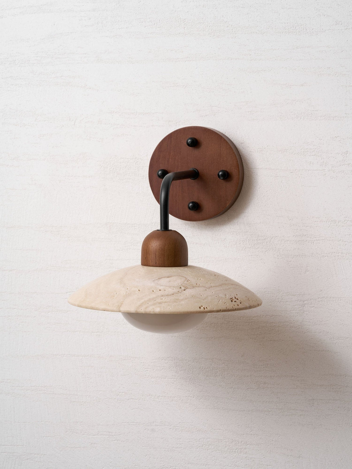 Boticas dome sconce with natural travertine veining detail