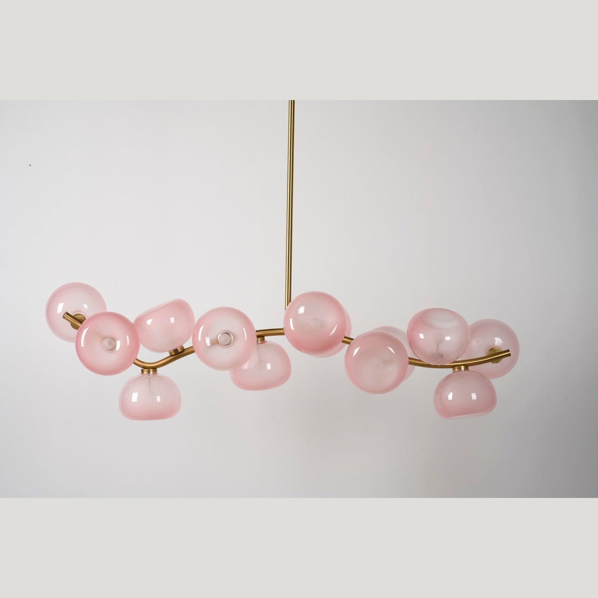 Blush glass chandelier unlit — real product photograph