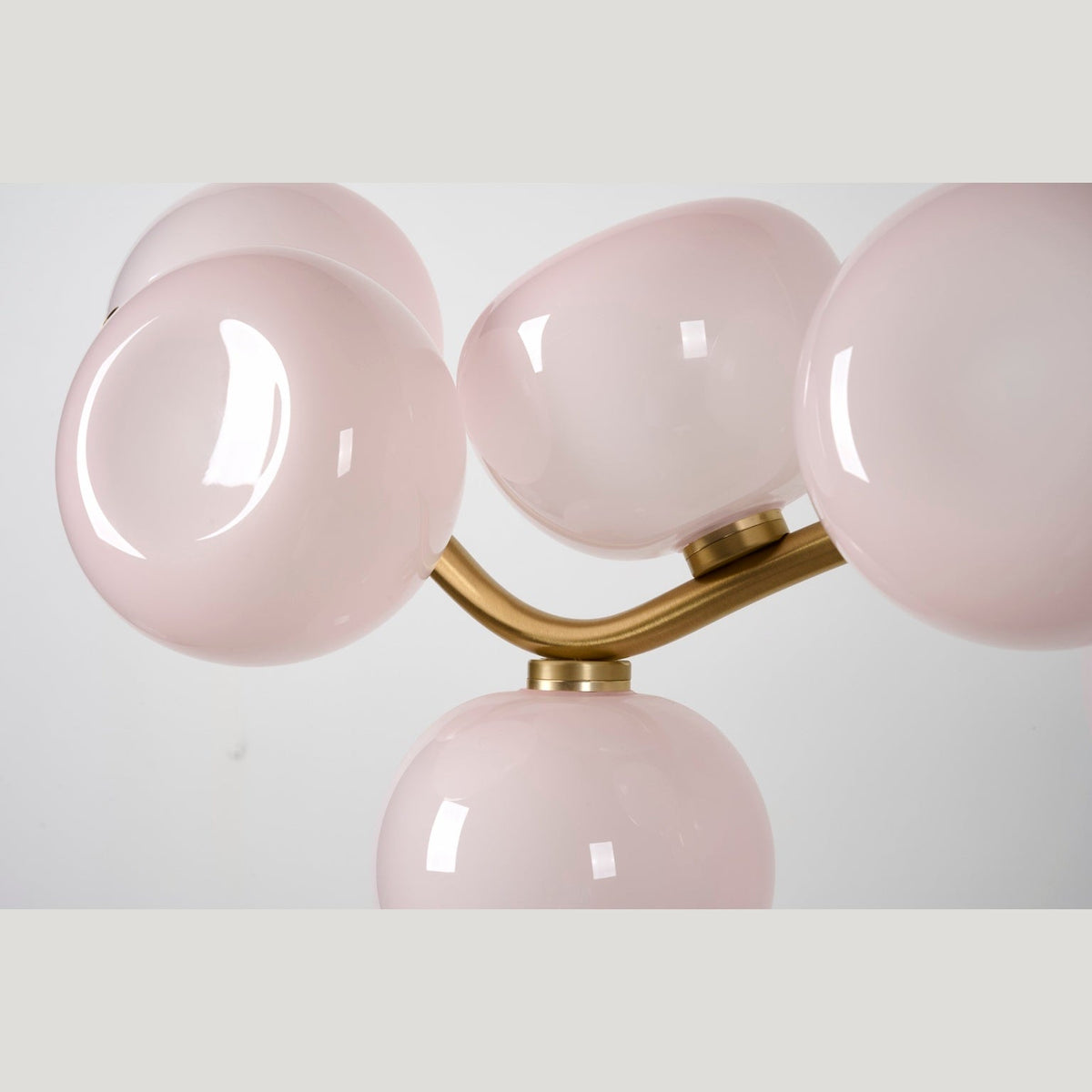 Blush glass shade and brass detail — real product photograph
