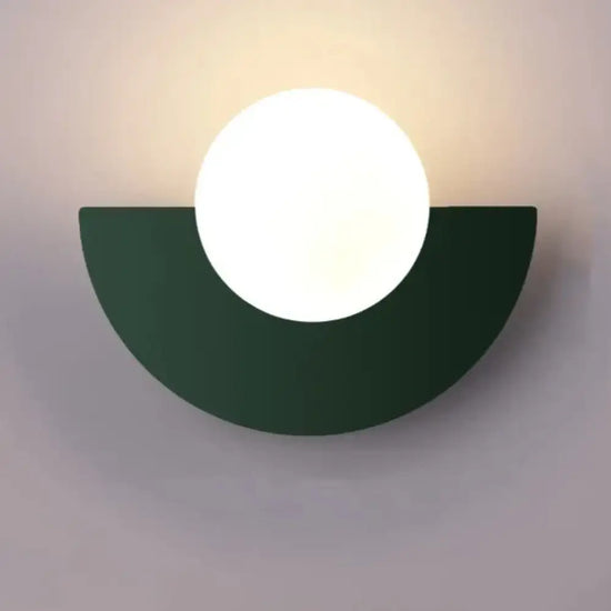 Cleo semicircle globe wall sconce in dark green with warm light