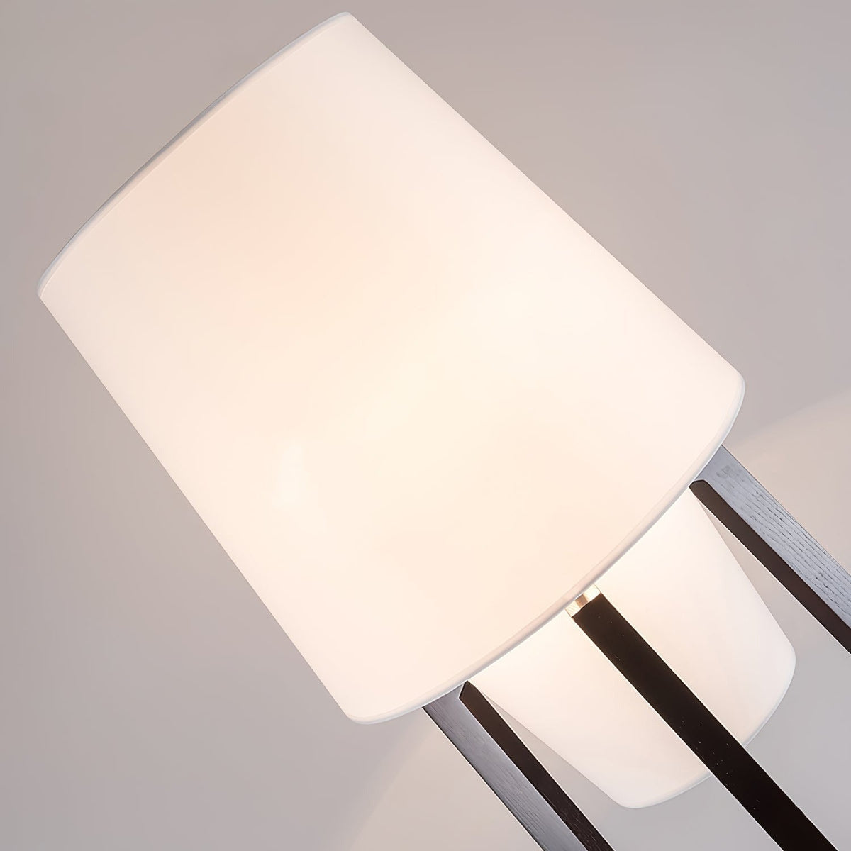 Close view of the Morros linen shade where the walnut legs hold it