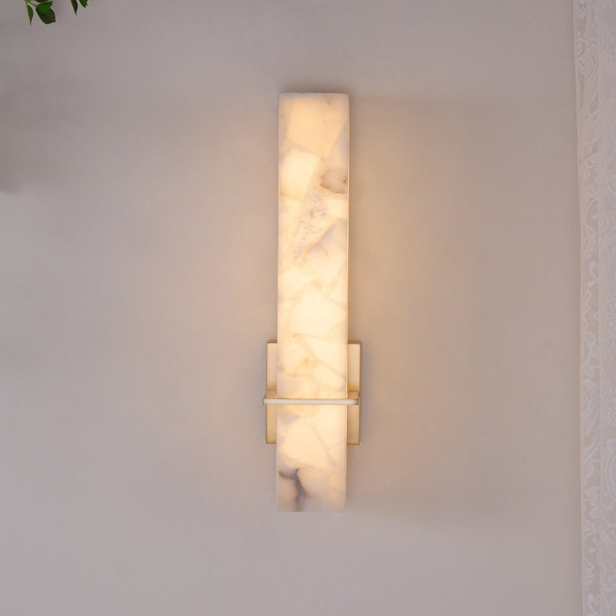 Detail of brass mounting hardware on alabaster sconce