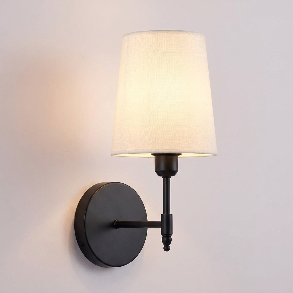 Battery operated wall sconce with fabric shade in black, wall mounted and lit