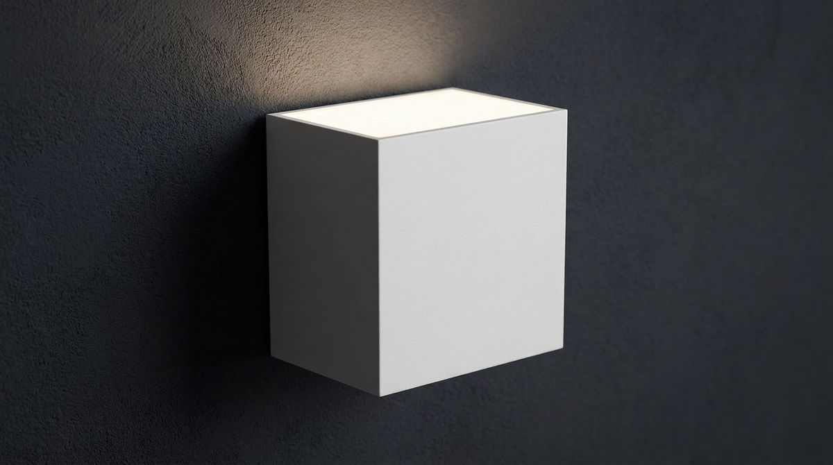 Detail of the up and down sconce casting light up a charcoal wall