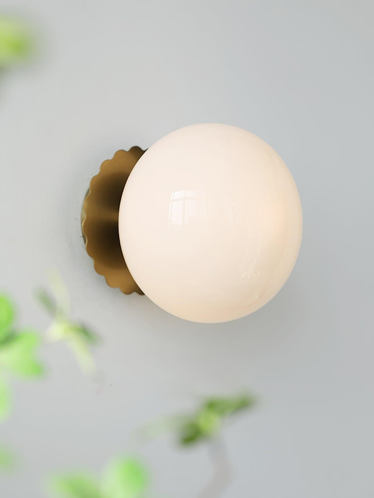 Marshmallow sconce creating warm glow in room setting