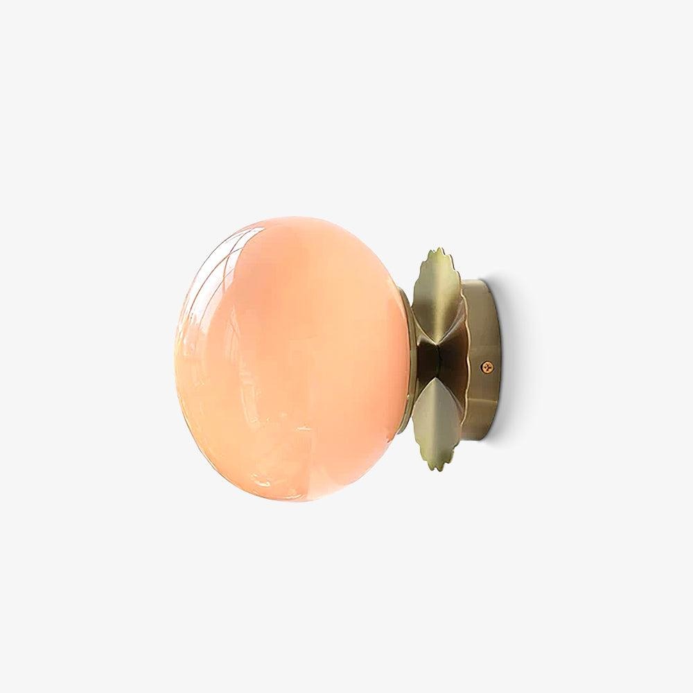 Marshmallow wall sconce with gold finish and white tinted glass, hero studio shot