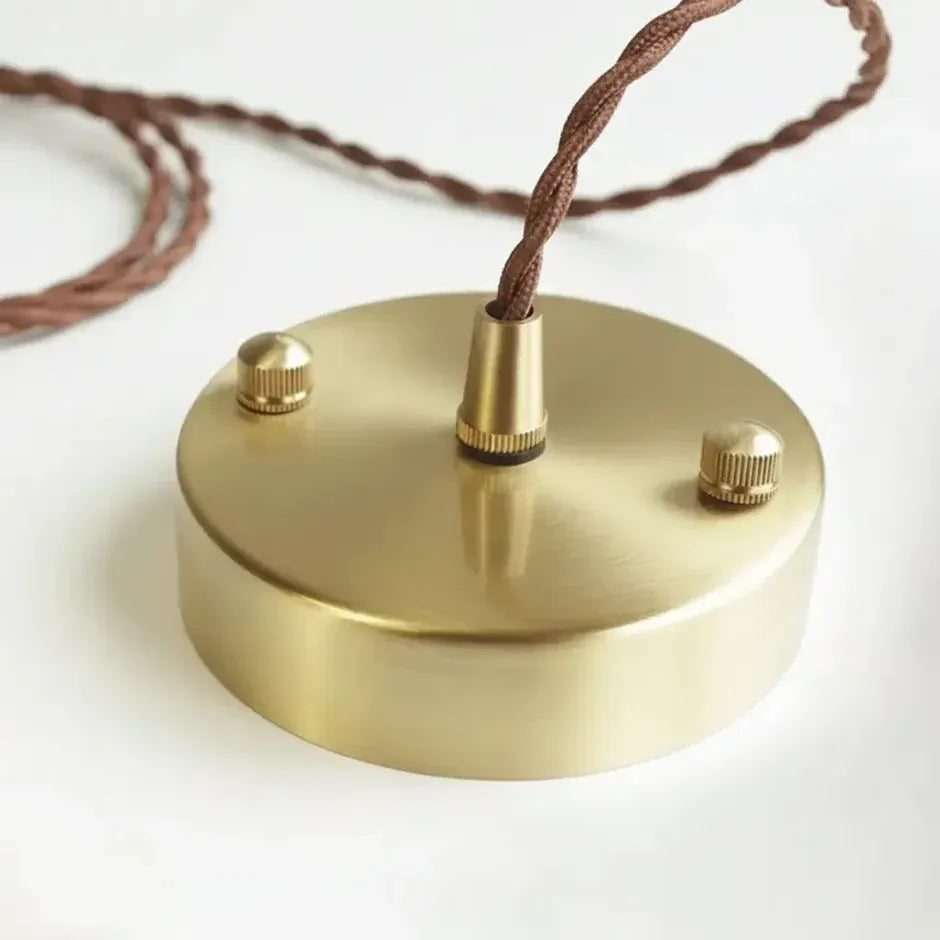 Gold finish ceiling canopy and brown twisted cord of the Mira ceramic pendant light