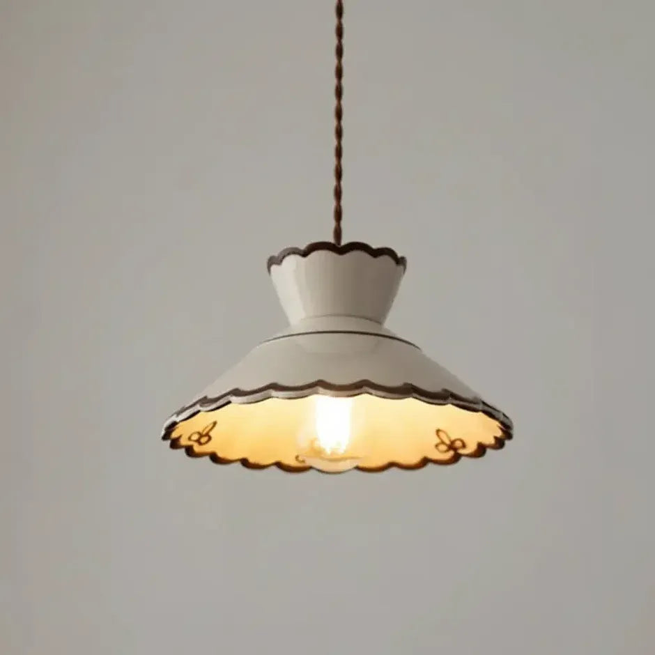 Mira scalloped ceramic pendant light illuminated with warm light