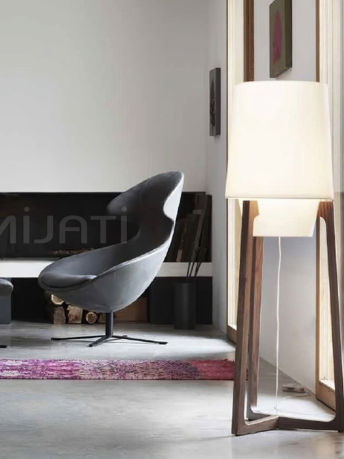 Morros floor lamp lit beside a dark lounge chair