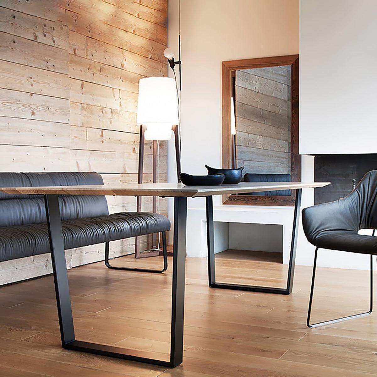 Morros floor lamp lit beside a dining table in a wood-panelled room