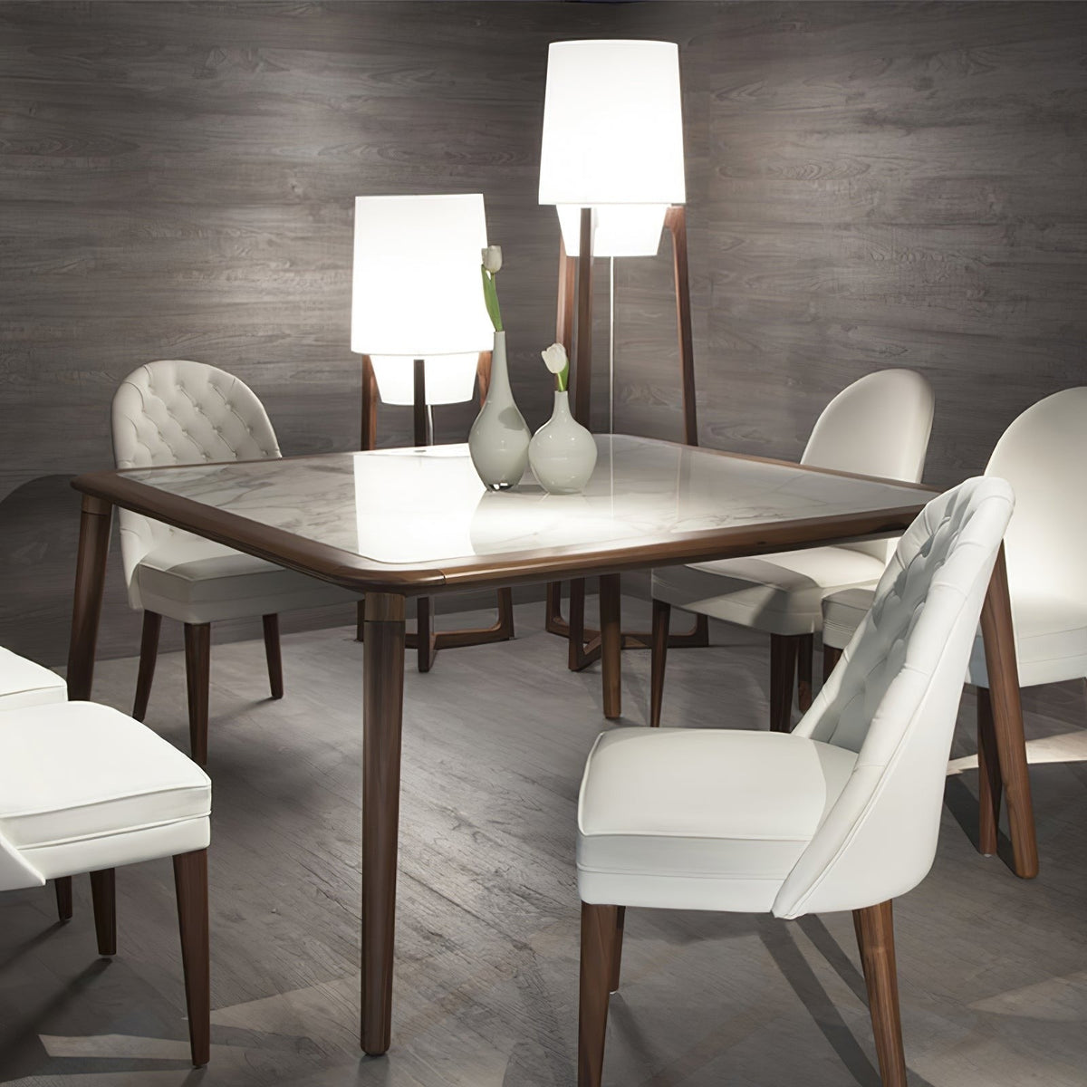 Morros floor lamps lit behind a dining table with cream chairs