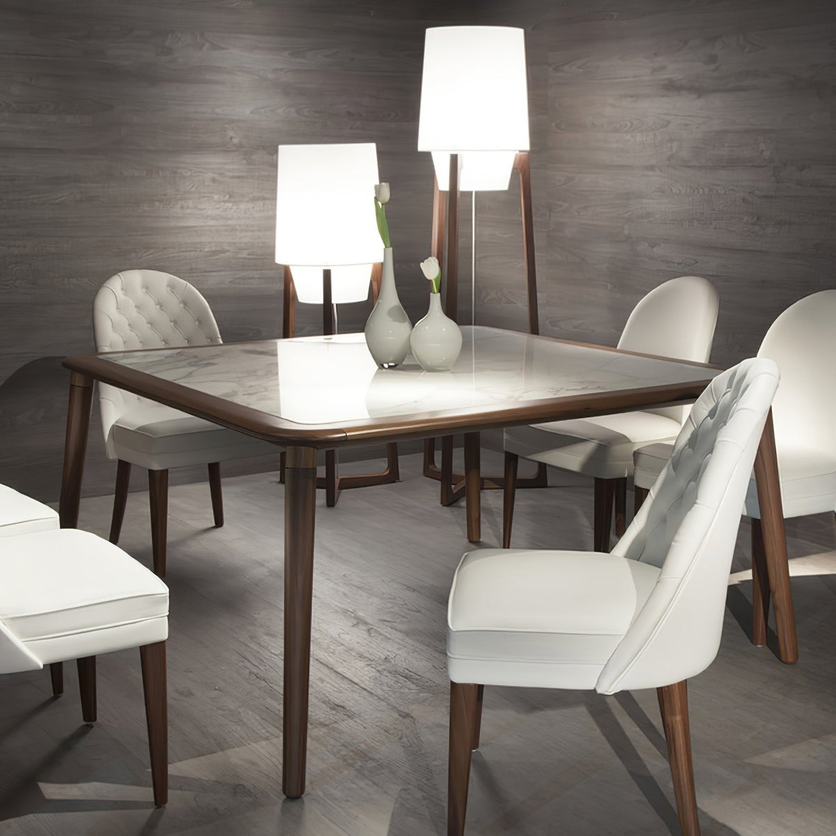 Morros floor lamps lit behind a dining table with white chairs
