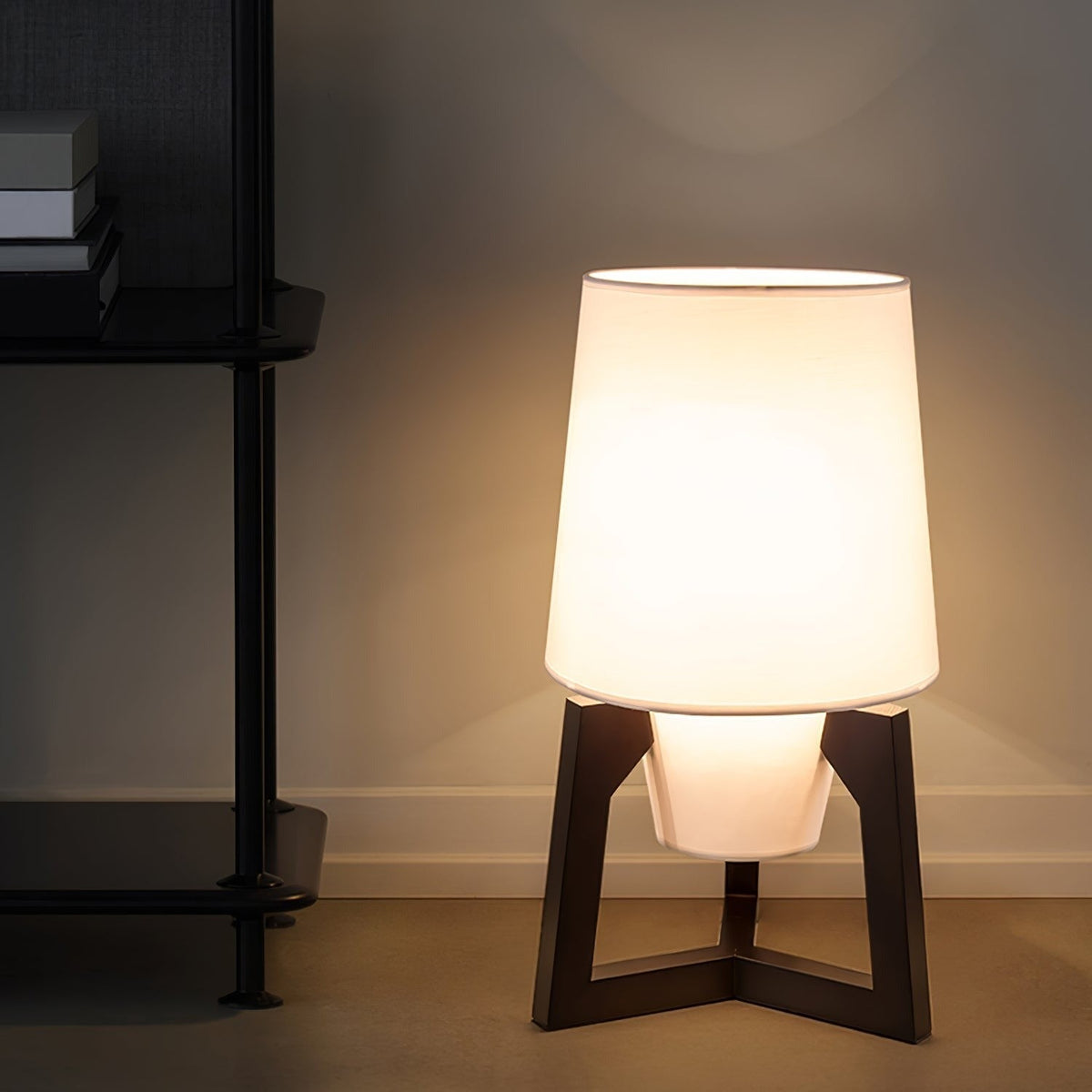 Morros small size lit, linen shade glowing in a dark room
