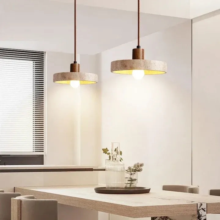 Two Runa travertine and walnut pendant lights above a dining table