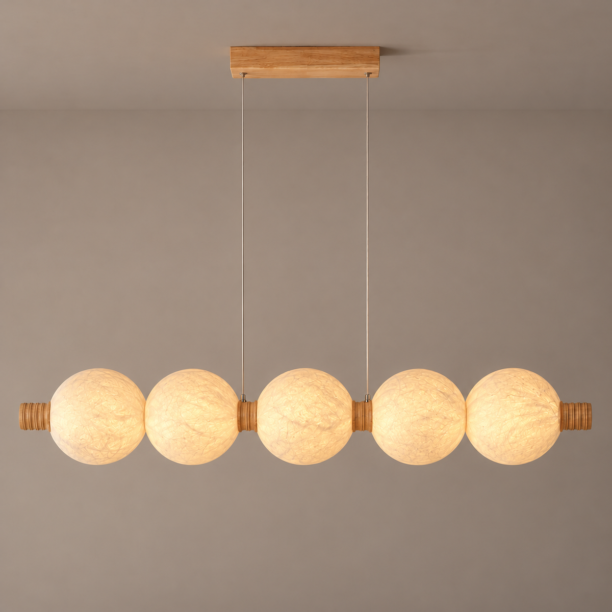 Five-globe natural mulberry silk linear pendant with light wood details and two central wooden suspension collars, full product hero