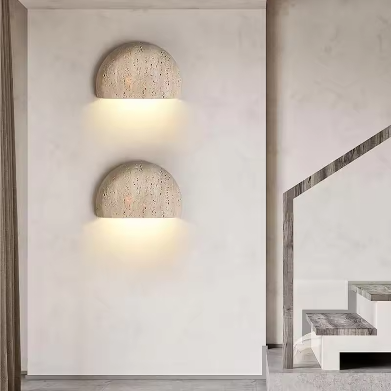 Two Sora travertine wall sconces along a staircase