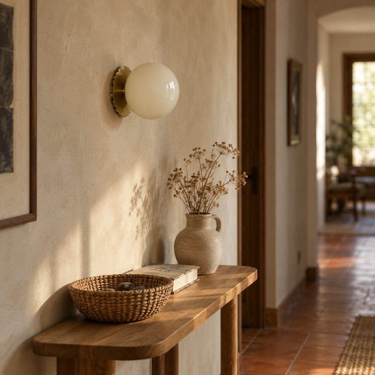 Tâmega convertible wall sconce with beige glass above an oak console in a tiled hallway.