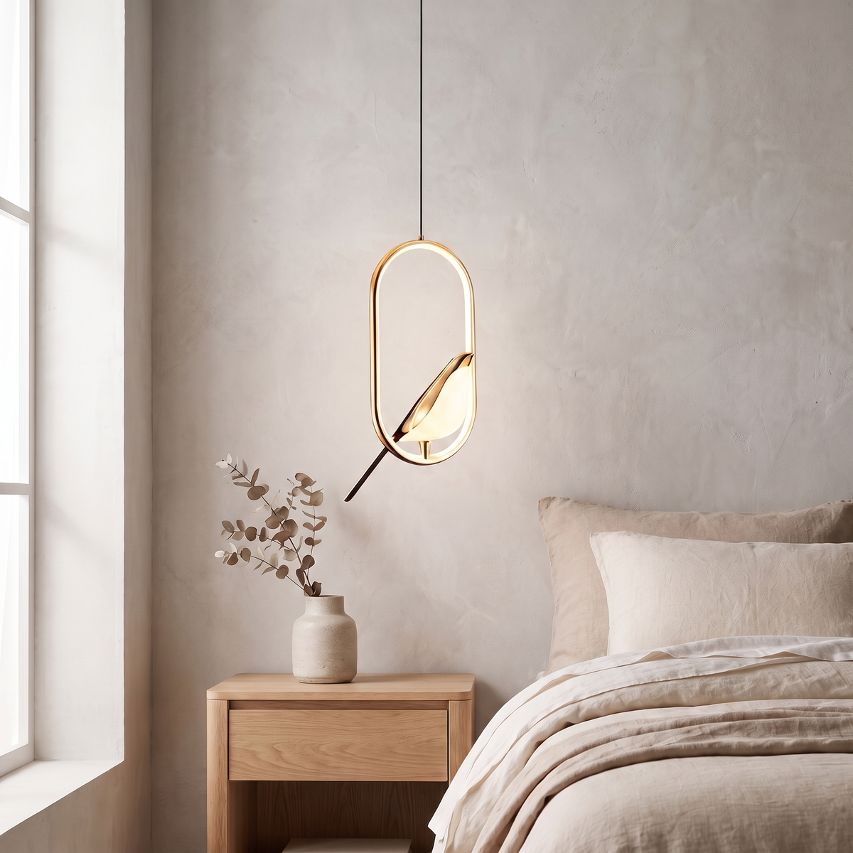 Tind bird pendant light, gold oval frame, above an oak nightstand