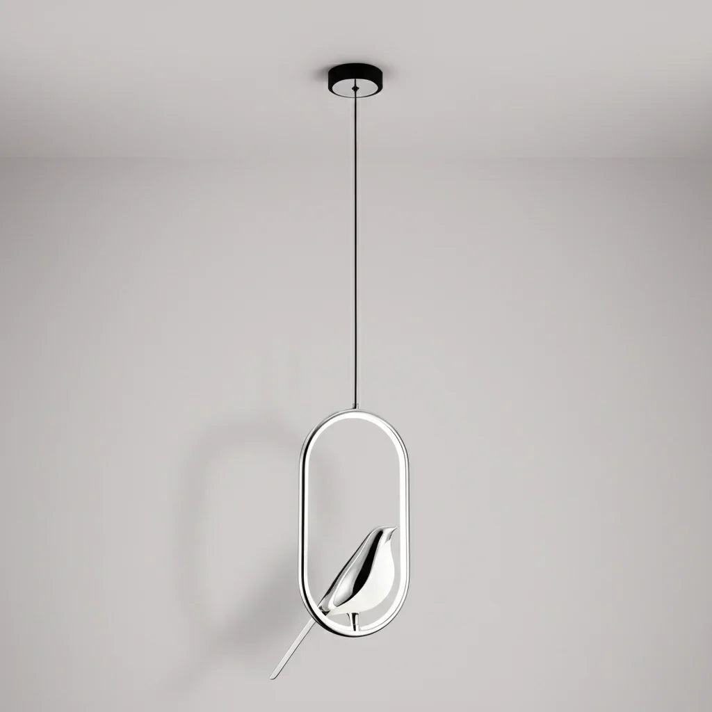 Silver oval frame bird pendant with a silver bird against a pale gray wall