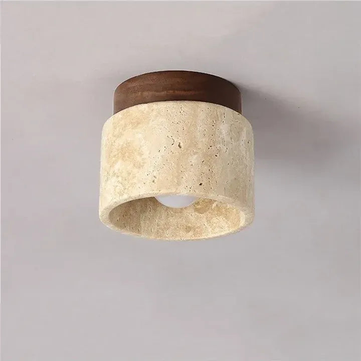 Tova cylindrical travertine flush mount ceiling light shown with the bulb switched off
