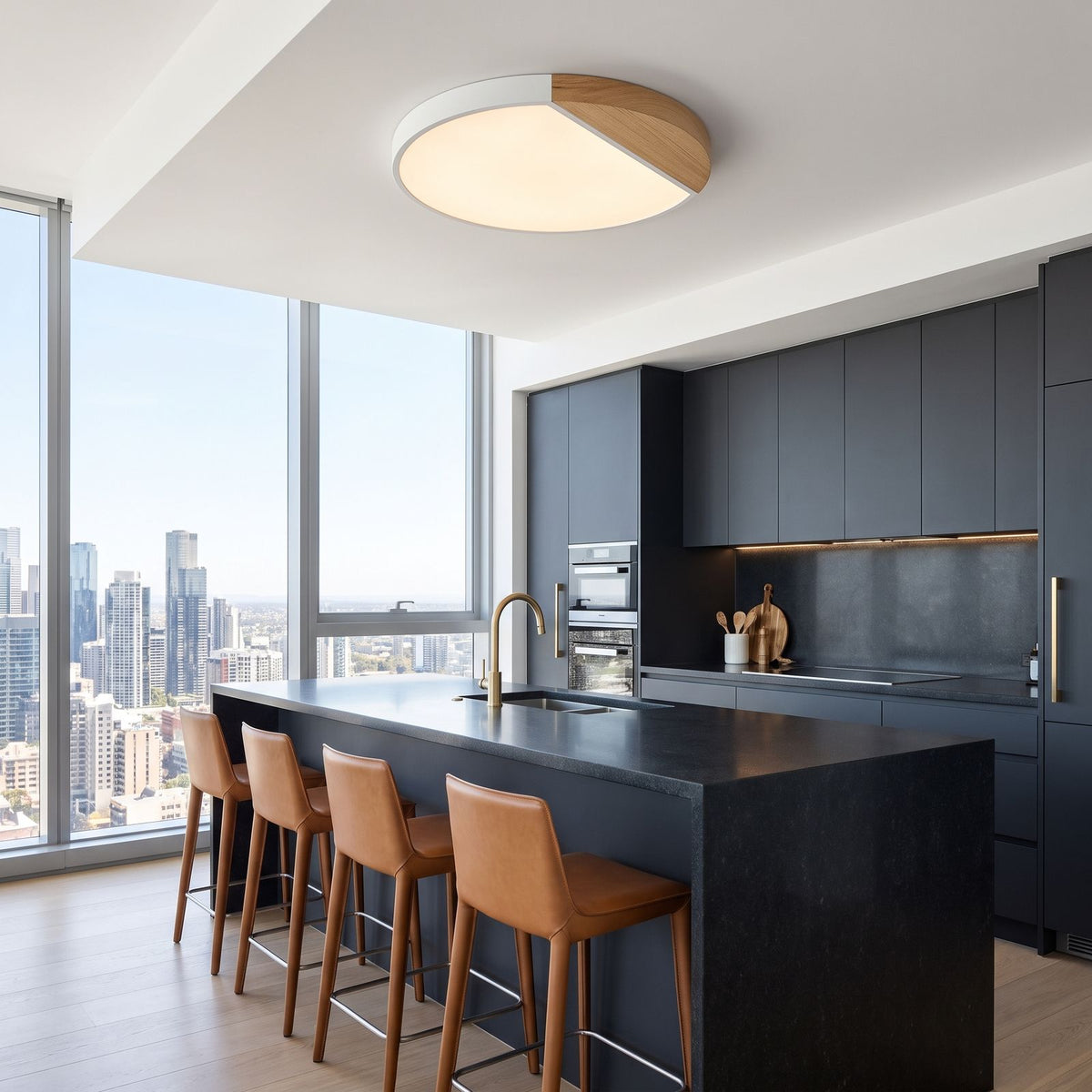 White ultra thin LED oyster ceiling light above a dark stone island in a penthouse kitchen