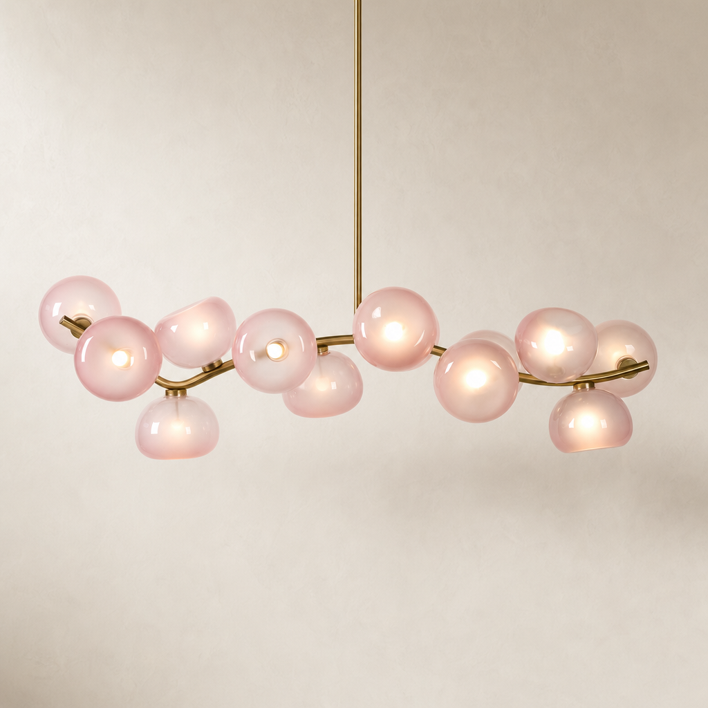 Blush glass 13-light linear chandelier in Natural Brass on a warm neutral background