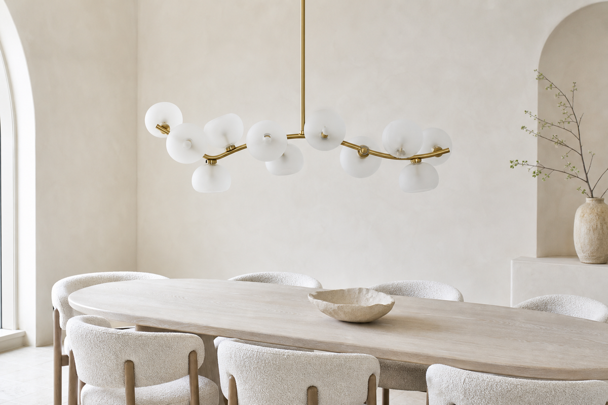 Frosted glass 13-light linear chandelier with the lights off in a bright modern dining room