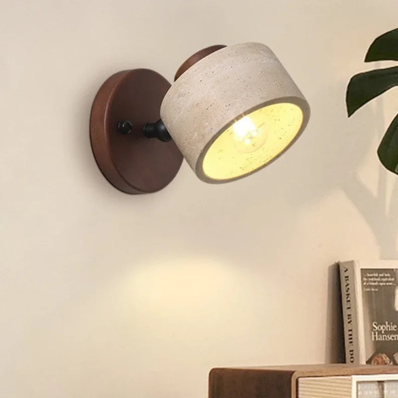 Yellow cave stone wall light with walnut plate, lit close-up