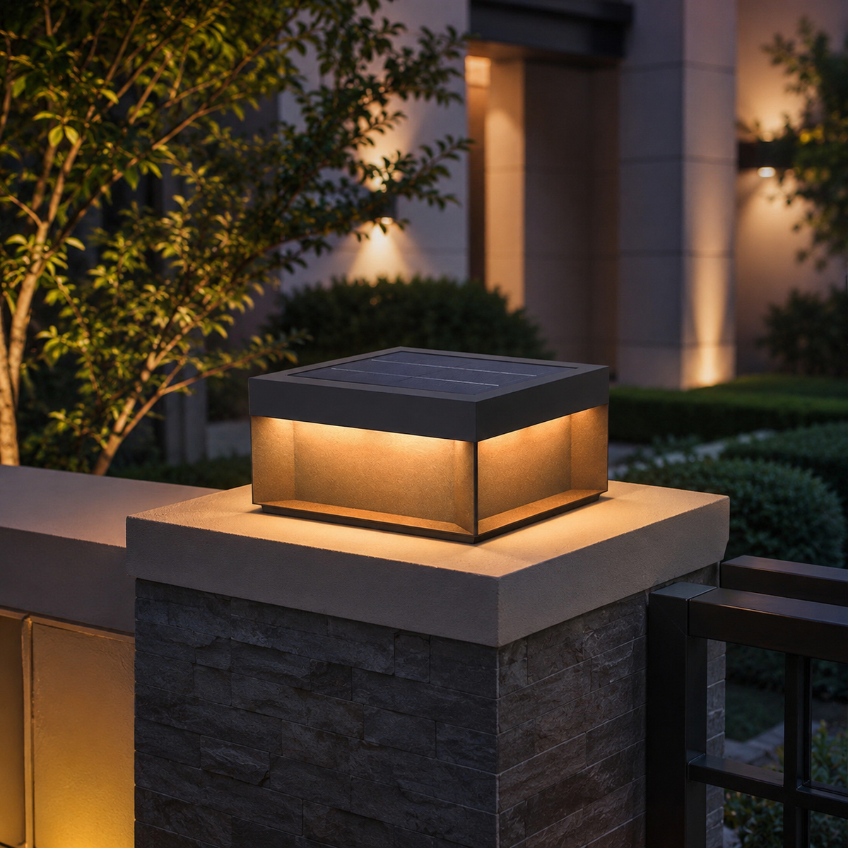 Alcacer solar box light on stone pillar at dusk, framed by tree and lit columns