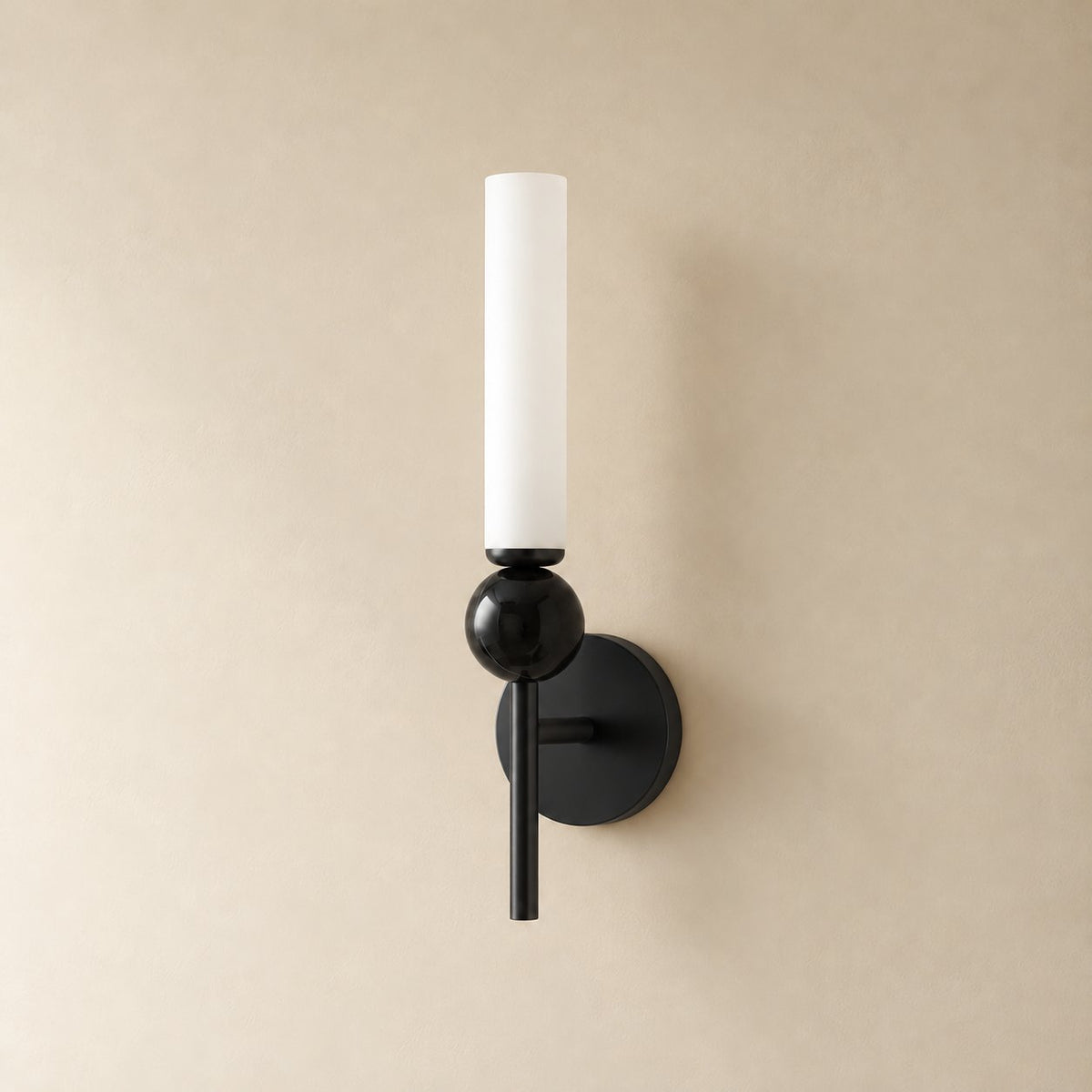 Aljezur vertical marble wall sconce in black with black marble, Model B (38.5 cm), unlit on a plain plaster wall.