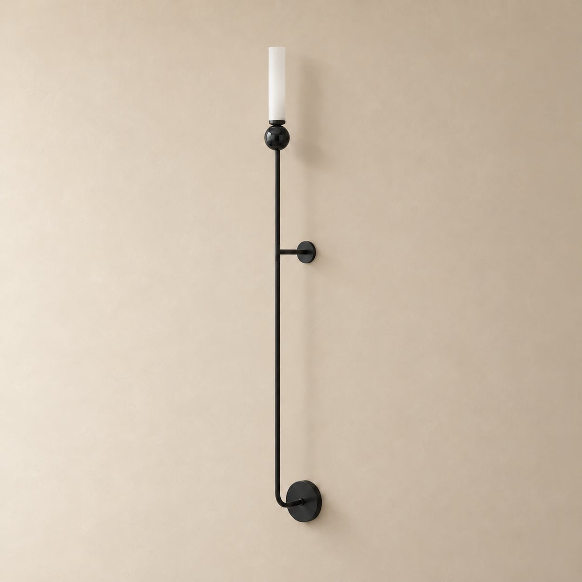 Aljezur vertical marble wall sconce in black with black marble, Model C (115 cm), unlit on a plain plaster wall.