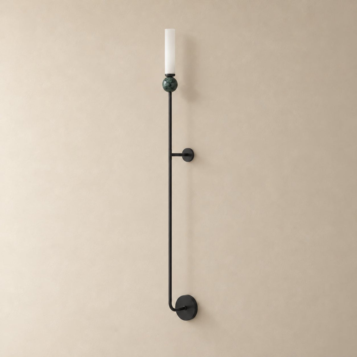 Aljezur vertical marble wall sconce in black with green marble, Model C (115 cm), unlit on a plain plaster wall.
