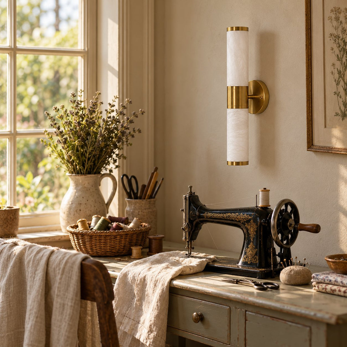 Beja alabaster wall sconce with brass bands above a vintage sewing table.