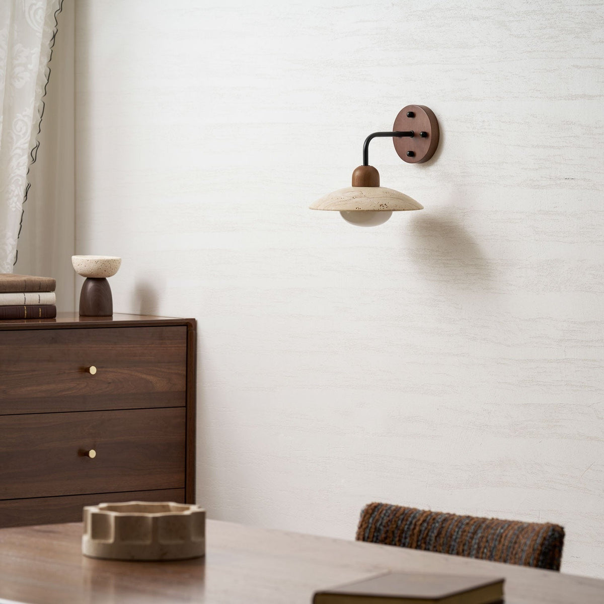 Boticas travertine dome sconce with gold hardware mounted on wall