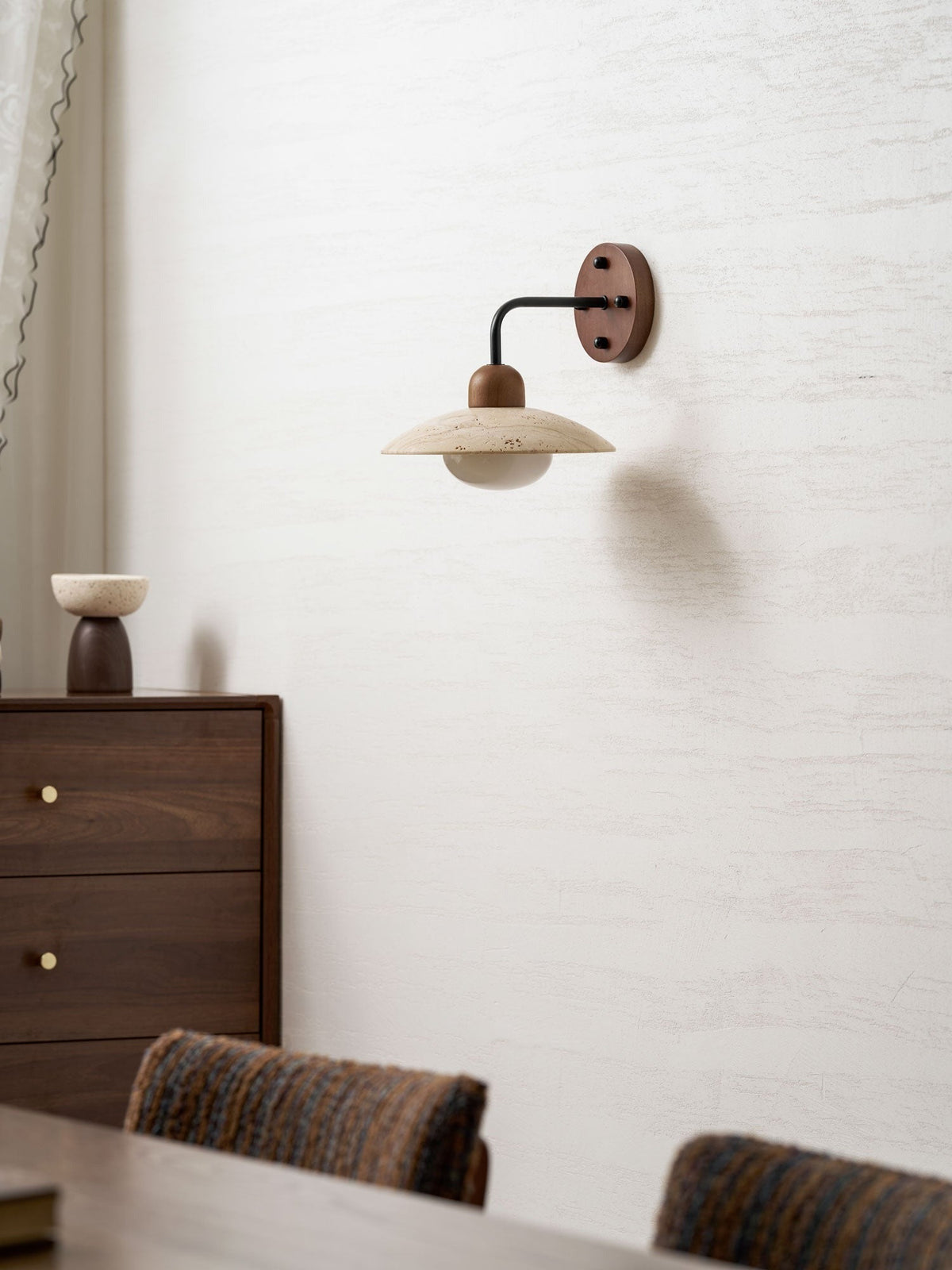 Boticas wall sconce installed in bedroom creating warm ambient light
