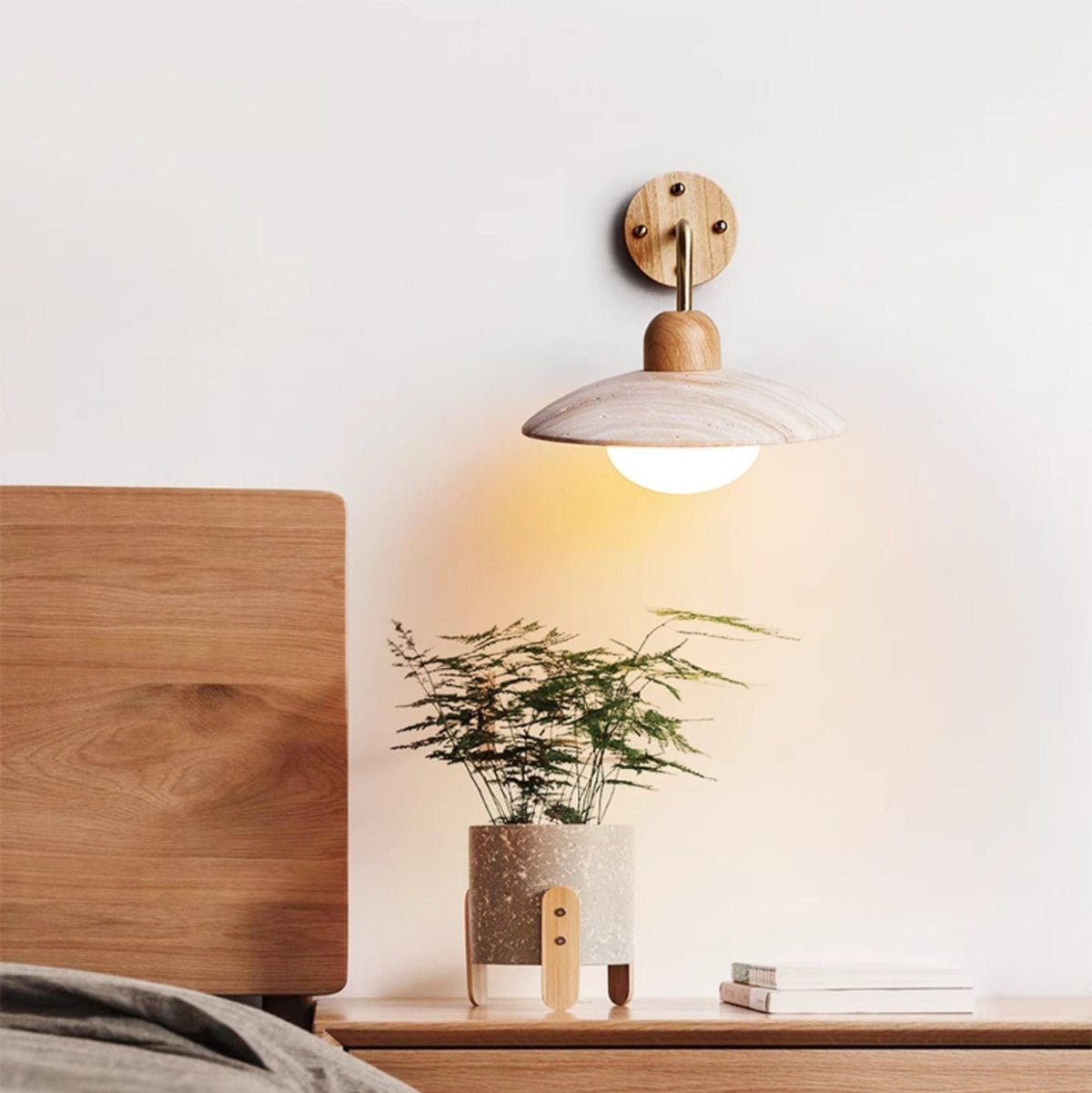 Boticas wall sconce showing curved brass arm extension