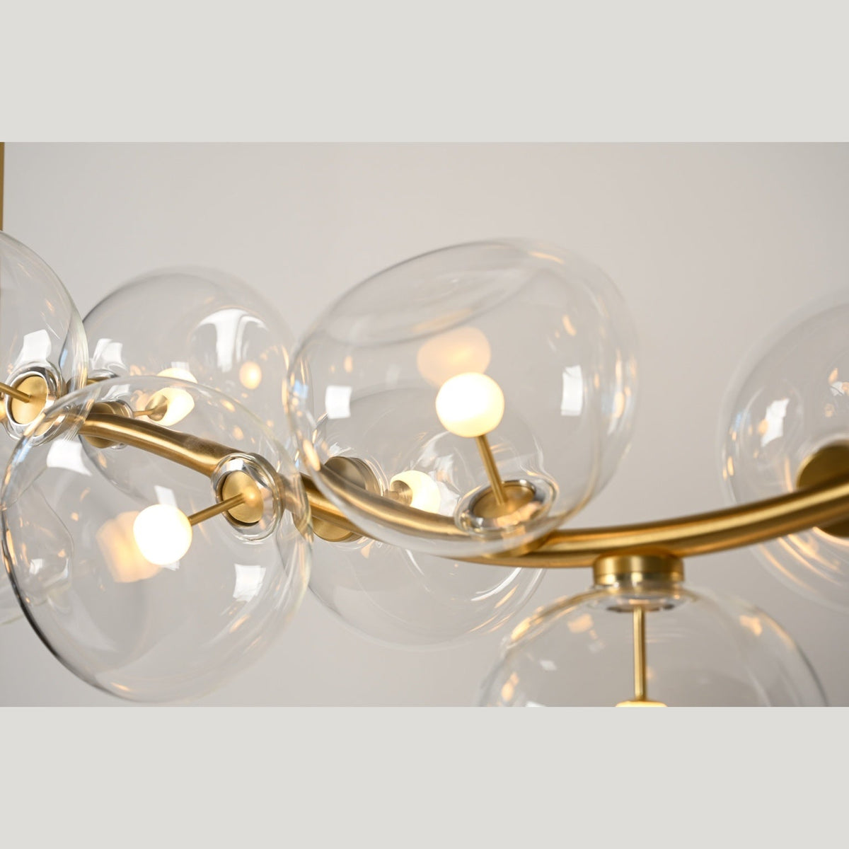 Illuminated clear glass and brass detail — real product photograph