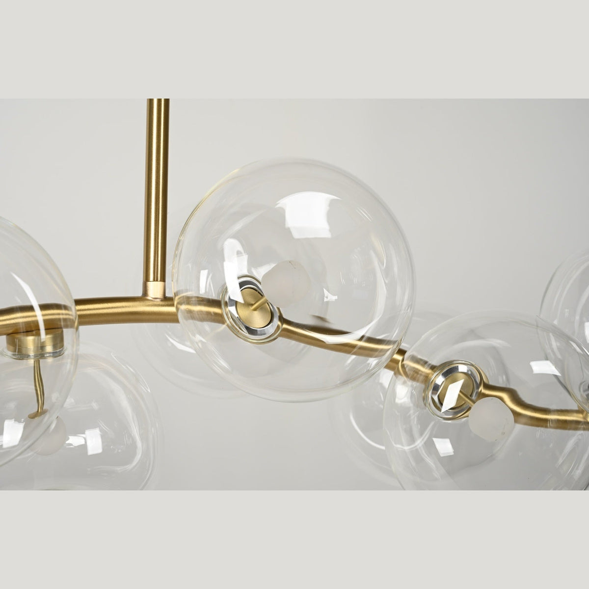 Clear glass shade and brass connection detail — real product photograph