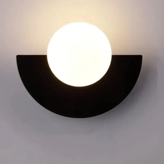 Cleo semicircle globe wall sconce in black with warm light