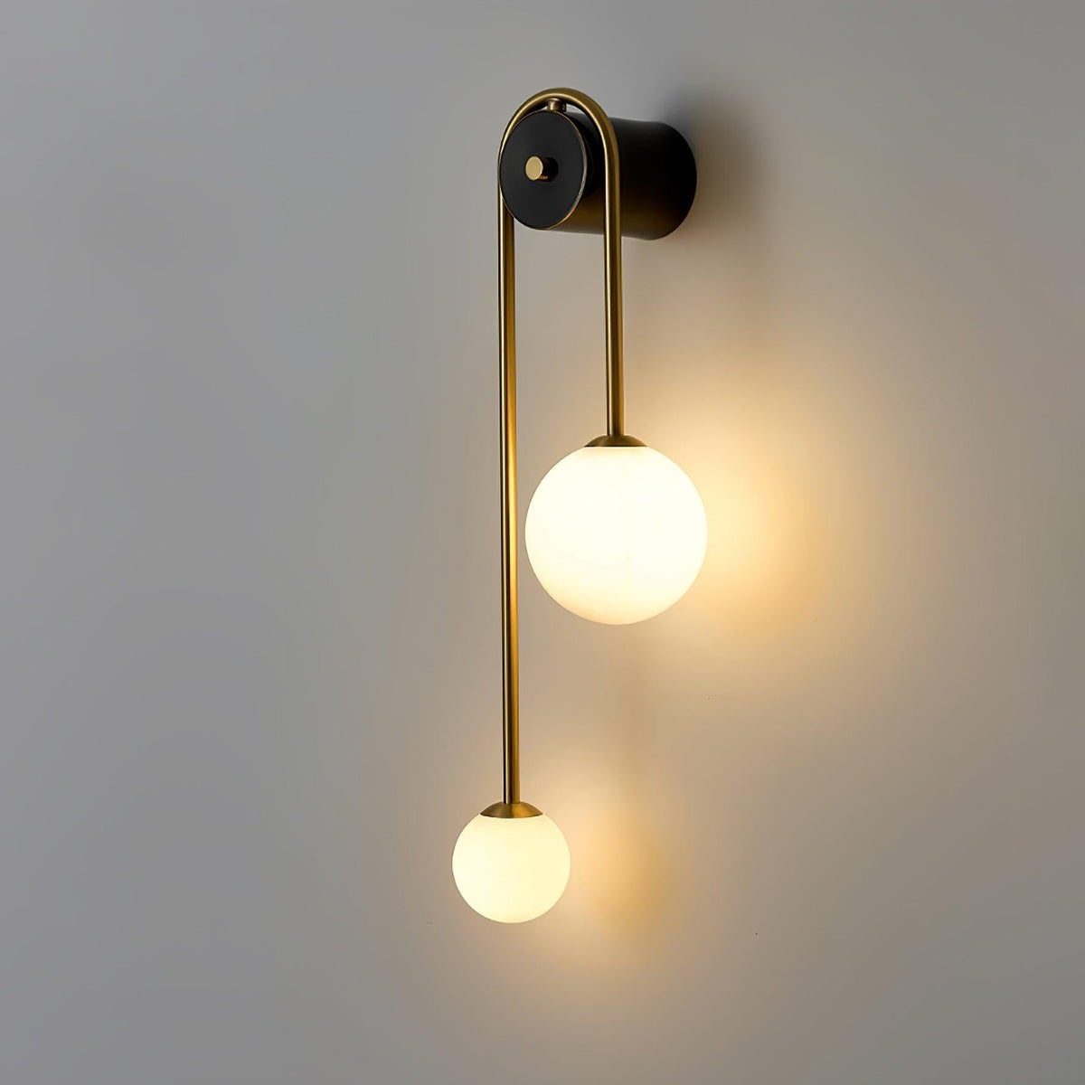 Close-up of curved brass arm on Alcoutim wall sconce