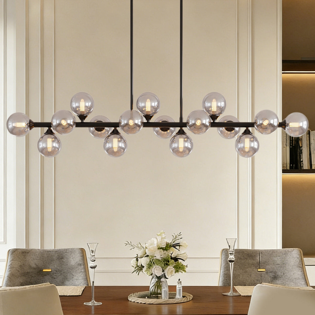 Orbit 16-light linear sputnik chandelier with smoky gray bubble glass globes hanging over a dining table