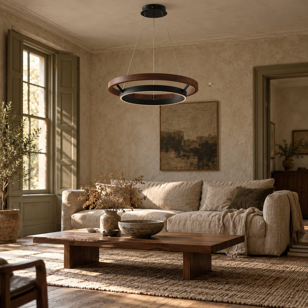 Espargos walnut and black ring pendant light above a wood coffee table in a living room.