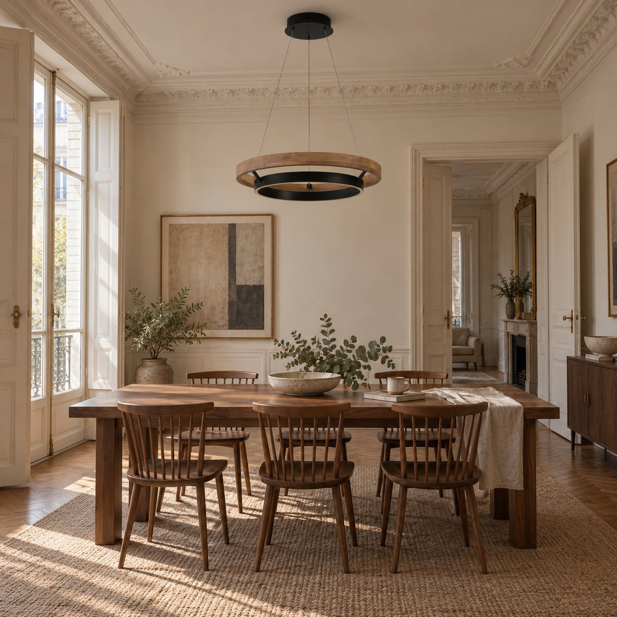 Espargos wood and black ring pendant light above a farmhouse dining table in a classic Parisian room.